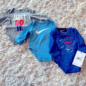 NWT Nike set of three bodysuits, NB.  Grey, light blue and blue.